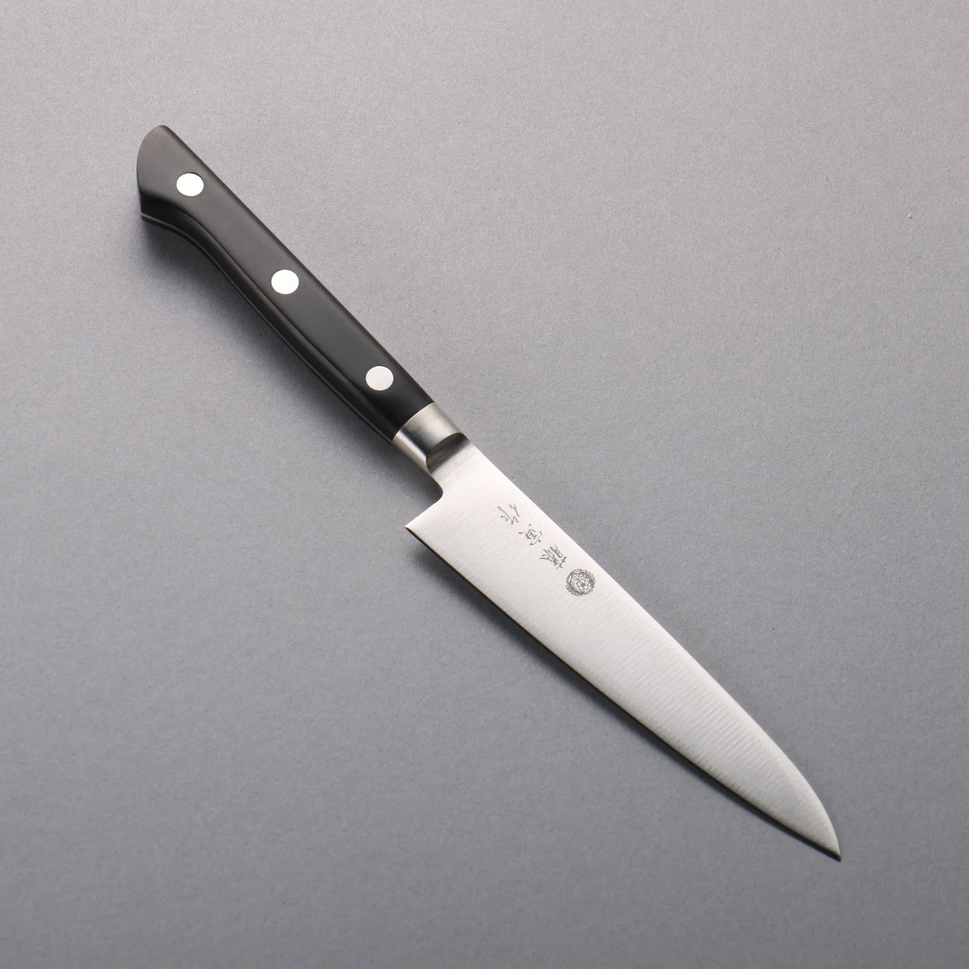 Cuchillo utilitario japonés Petty Tojiro 120mm con hoja de acero VG10 y mango reforzado, ideal para cortes pequeños y precisos.